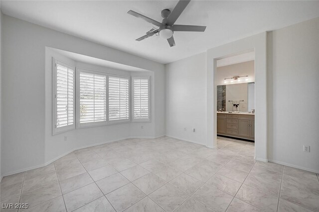 tiled spare room featuring ceiling fan