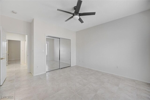 unfurnished bedroom featuring a closet, ceiling fan, and light tile patterned floors