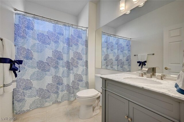 bathroom featuring tile patterned flooring, vanity, and toilet