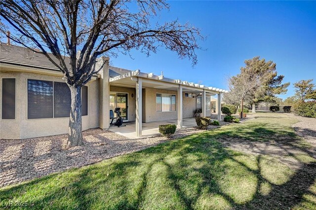 back of property with a patio area, a lawn, and a pergola