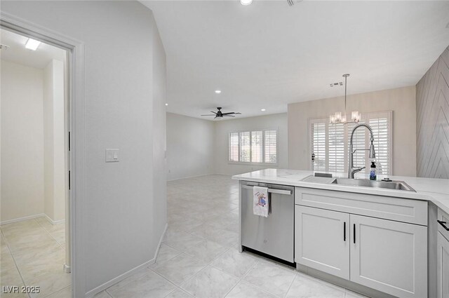 kitchen featuring sink, light tile patterned floors, stainless steel dishwasher, ceiling fan with notable chandelier, and hanging light fixtures