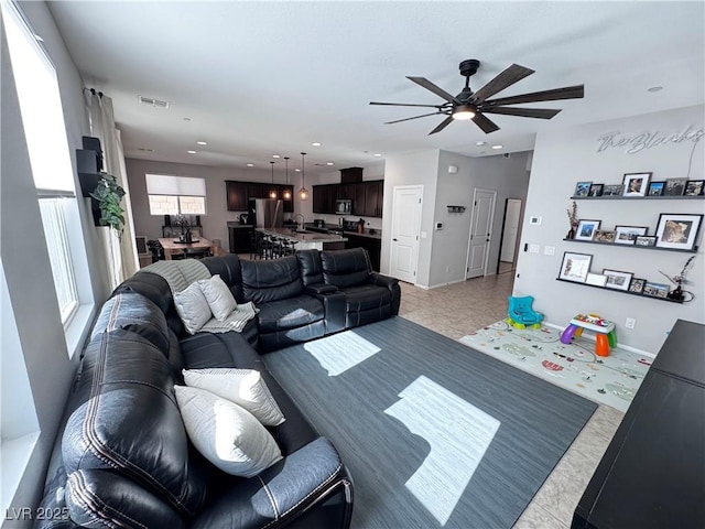 tiled living room featuring ceiling fan