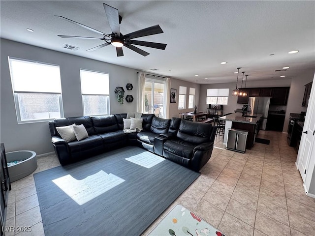 living room with light tile patterned flooring and ceiling fan