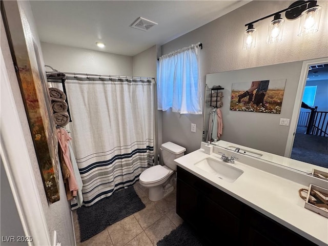 bathroom featuring tile patterned floors, vanity, and toilet