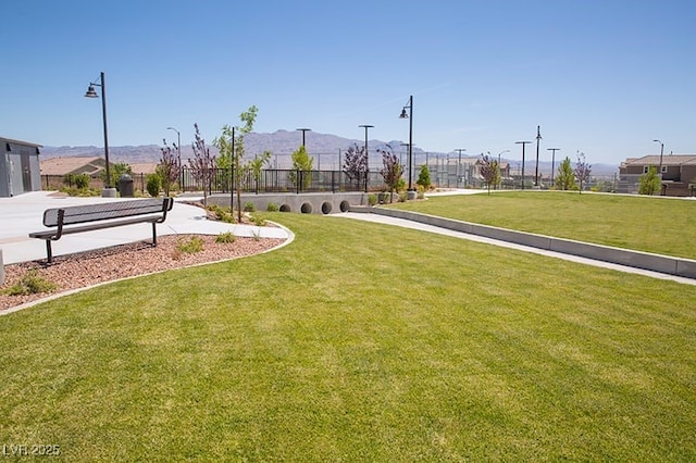 view of home's community featuring a mountain view and a lawn