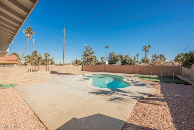 view of swimming pool with a patio and an in ground hot tub