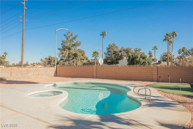 view of pool with an in ground hot tub