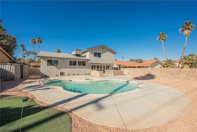 view of swimming pool featuring a jacuzzi and a patio