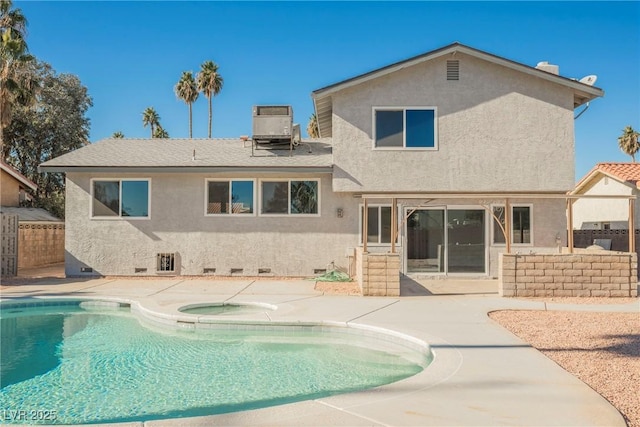 back of property with central AC, a patio area, and a swimming pool with hot tub