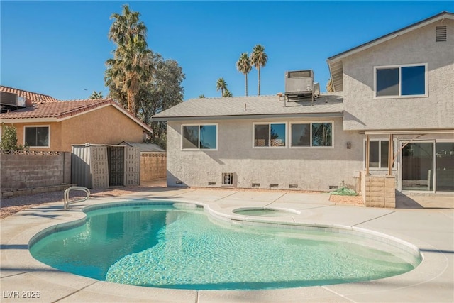 rear view of house with a patio, central air condition unit, and a swimming pool with hot tub