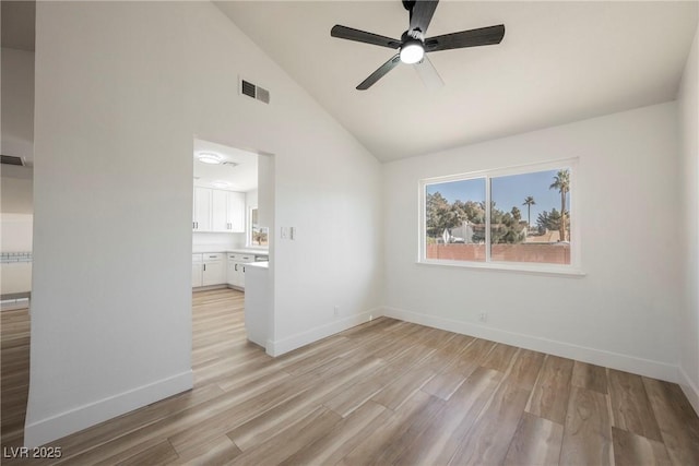 unfurnished room featuring ceiling fan, light hardwood / wood-style flooring, and vaulted ceiling