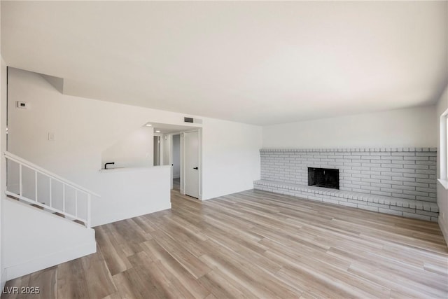 unfurnished living room with light hardwood / wood-style flooring and a fireplace