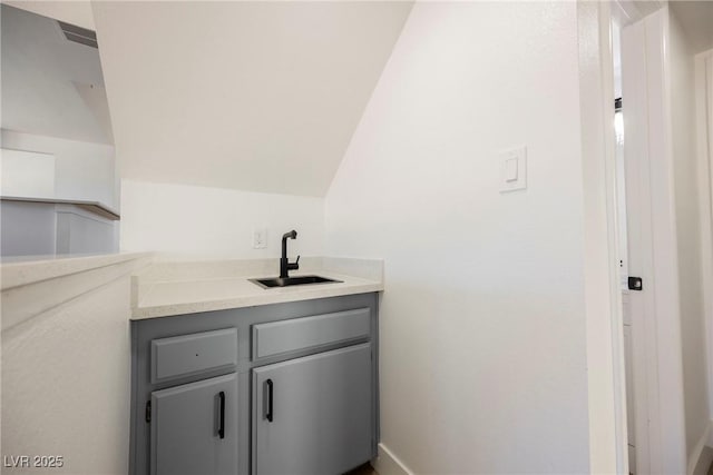 bathroom featuring vaulted ceiling and vanity