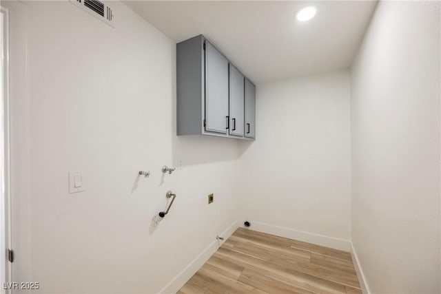 laundry room featuring hookup for a washing machine, cabinets, hookup for an electric dryer, and light hardwood / wood-style floors