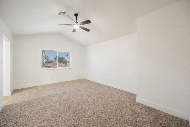 carpeted empty room featuring ceiling fan and vaulted ceiling