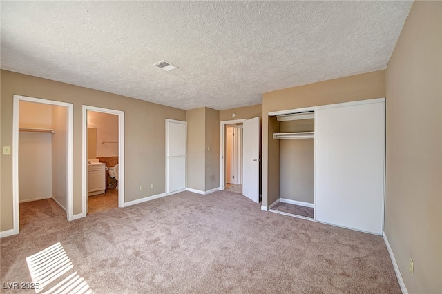 unfurnished bedroom featuring baseboards, visible vents, connected bathroom, carpet, and a closet