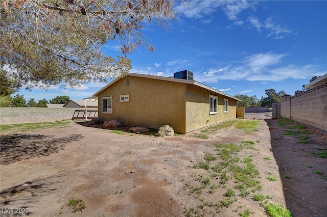 view of property exterior with a fenced backyard and stucco siding