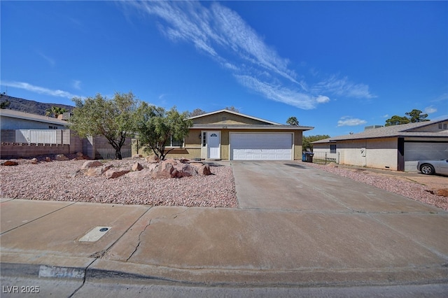 single story home with driveway, fence, and stucco siding