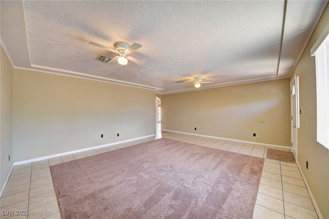 spare room featuring light tile patterned floors, ceiling fan, visible vents, and crown molding