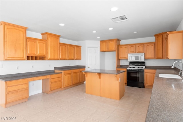 kitchen with sink, light tile patterned flooring, a center island, and range with gas stovetop