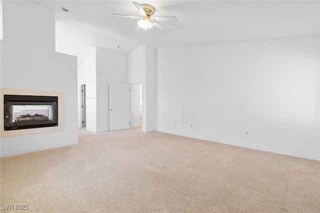 unfurnished living room featuring high vaulted ceiling, ceiling fan, a multi sided fireplace, and light carpet