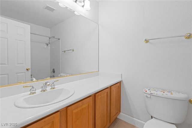 bathroom featuring vanity, tile patterned floors, and toilet