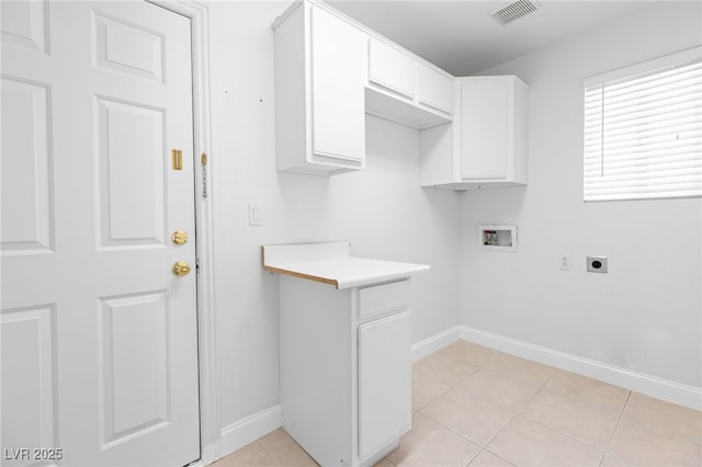 washroom featuring cabinets, hookup for a washing machine, light tile patterned flooring, and electric dryer hookup