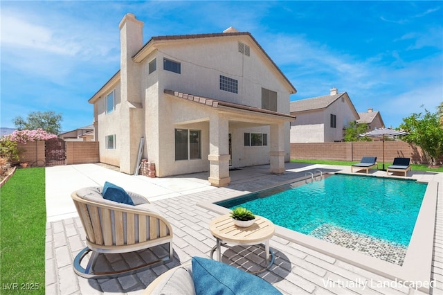 back of house with a patio and a fenced in pool