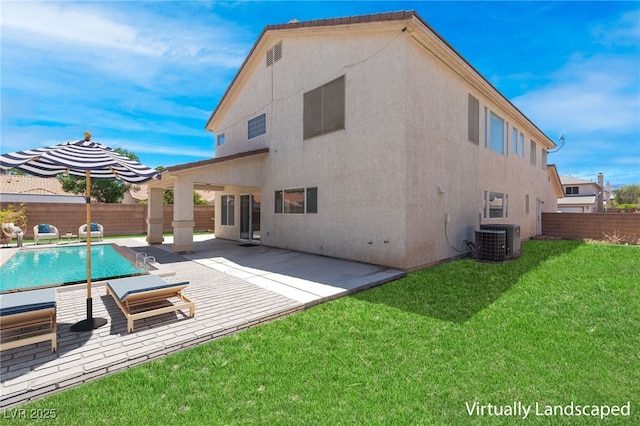 back of property featuring a yard, a fenced in pool, central air condition unit, and a patio