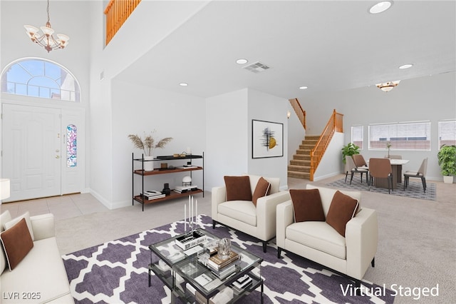 carpeted living room with an inviting chandelier