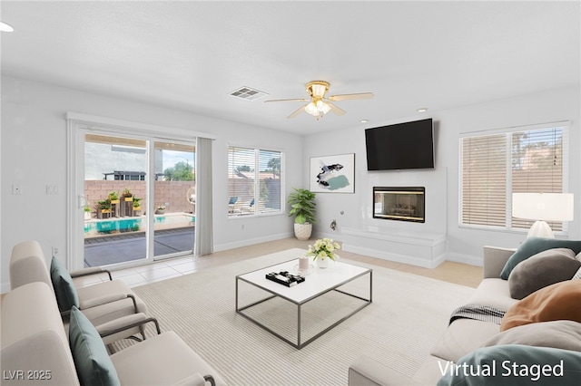 living room featuring ceiling fan and light tile patterned floors