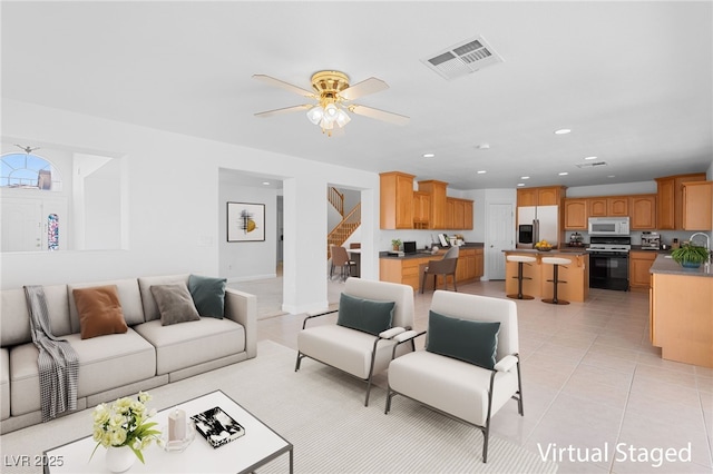 living room featuring ceiling fan and light tile patterned floors