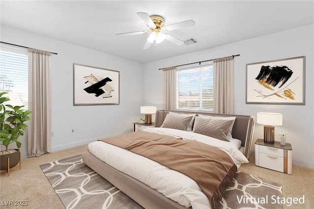 bedroom with light colored carpet and ceiling fan