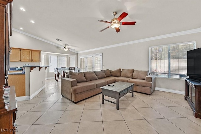 living room with vaulted ceiling, crown molding, and a wealth of natural light