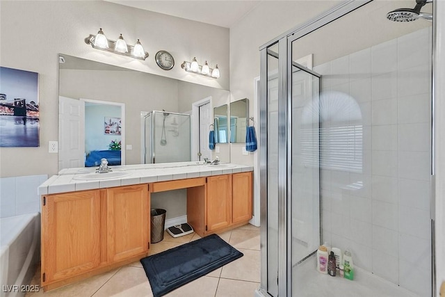 bathroom featuring vanity, tile patterned floors, and a shower with shower door