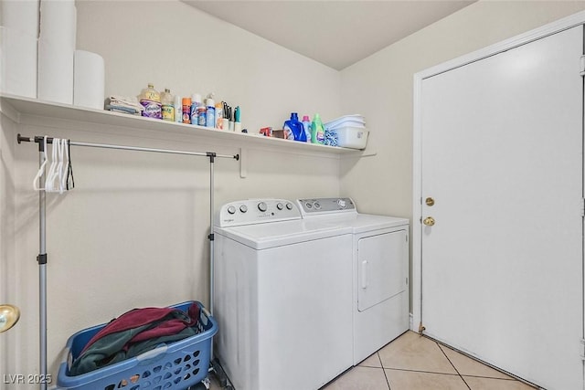 laundry area featuring separate washer and dryer and light tile patterned floors