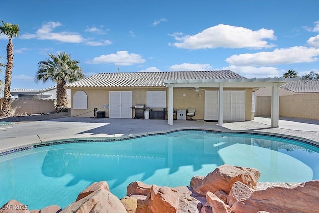 view of swimming pool with ceiling fan, area for grilling, a pergola, and a patio