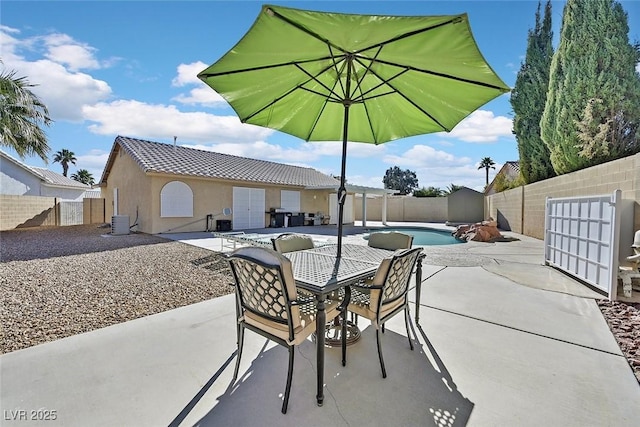 view of patio with central AC unit and a fenced in pool