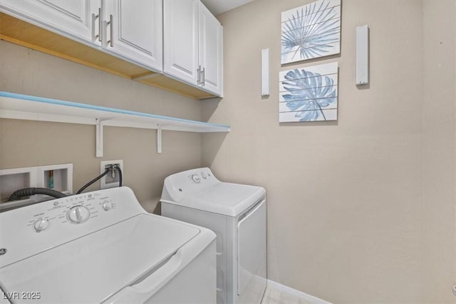 laundry area with cabinets and washing machine and clothes dryer