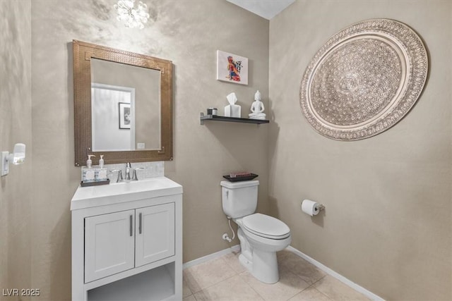 bathroom with toilet, tile patterned flooring, and vanity