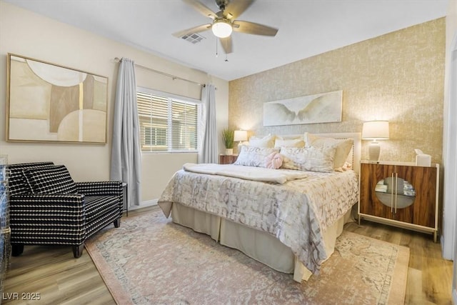 bedroom with hardwood / wood-style flooring and ceiling fan