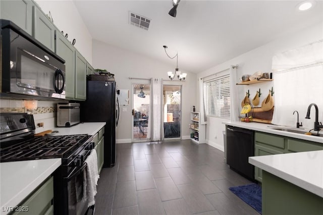 kitchen with sink, green cabinets, lofted ceiling, black appliances, and a notable chandelier