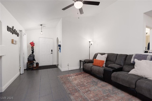 living room featuring ceiling fan, lofted ceiling, and dark hardwood / wood-style floors