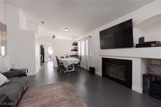 living room with dark hardwood / wood-style flooring and vaulted ceiling