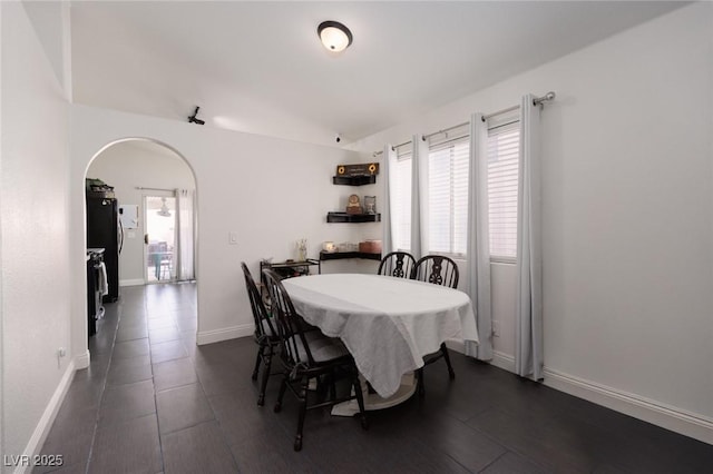 dining room with vaulted ceiling