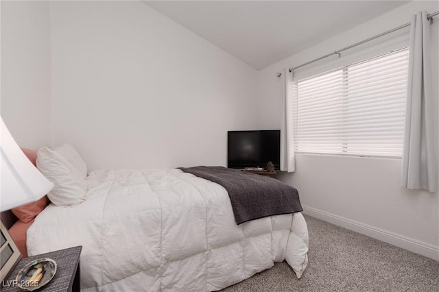 bedroom with lofted ceiling and carpet