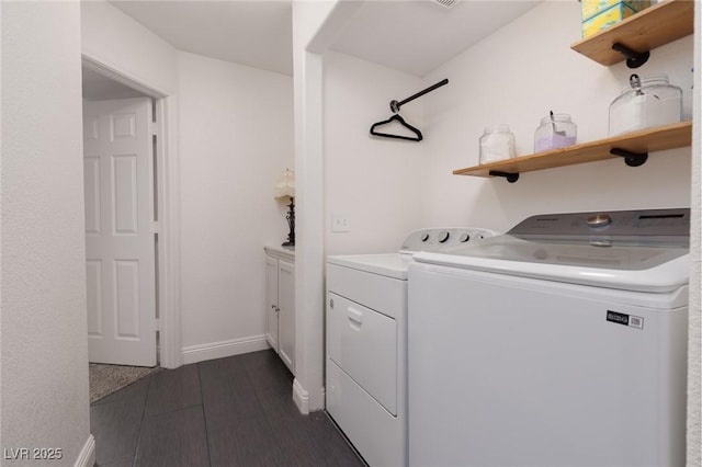 laundry room with separate washer and dryer and dark hardwood / wood-style floors