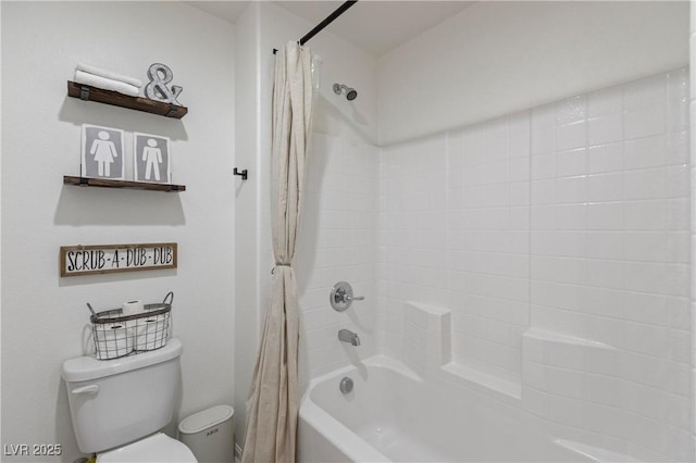 bathroom with toilet and shower / bath combo with shower curtain