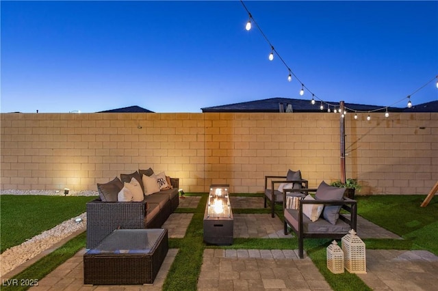 patio terrace at dusk featuring an outdoor living space with a fire pit