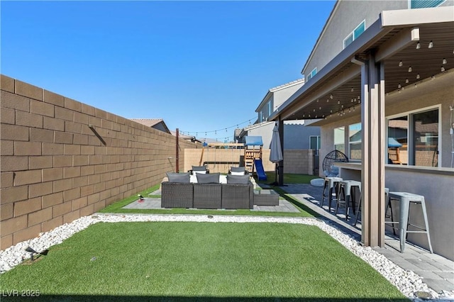 view of yard with exterior bar, a patio, and an outdoor hangout area